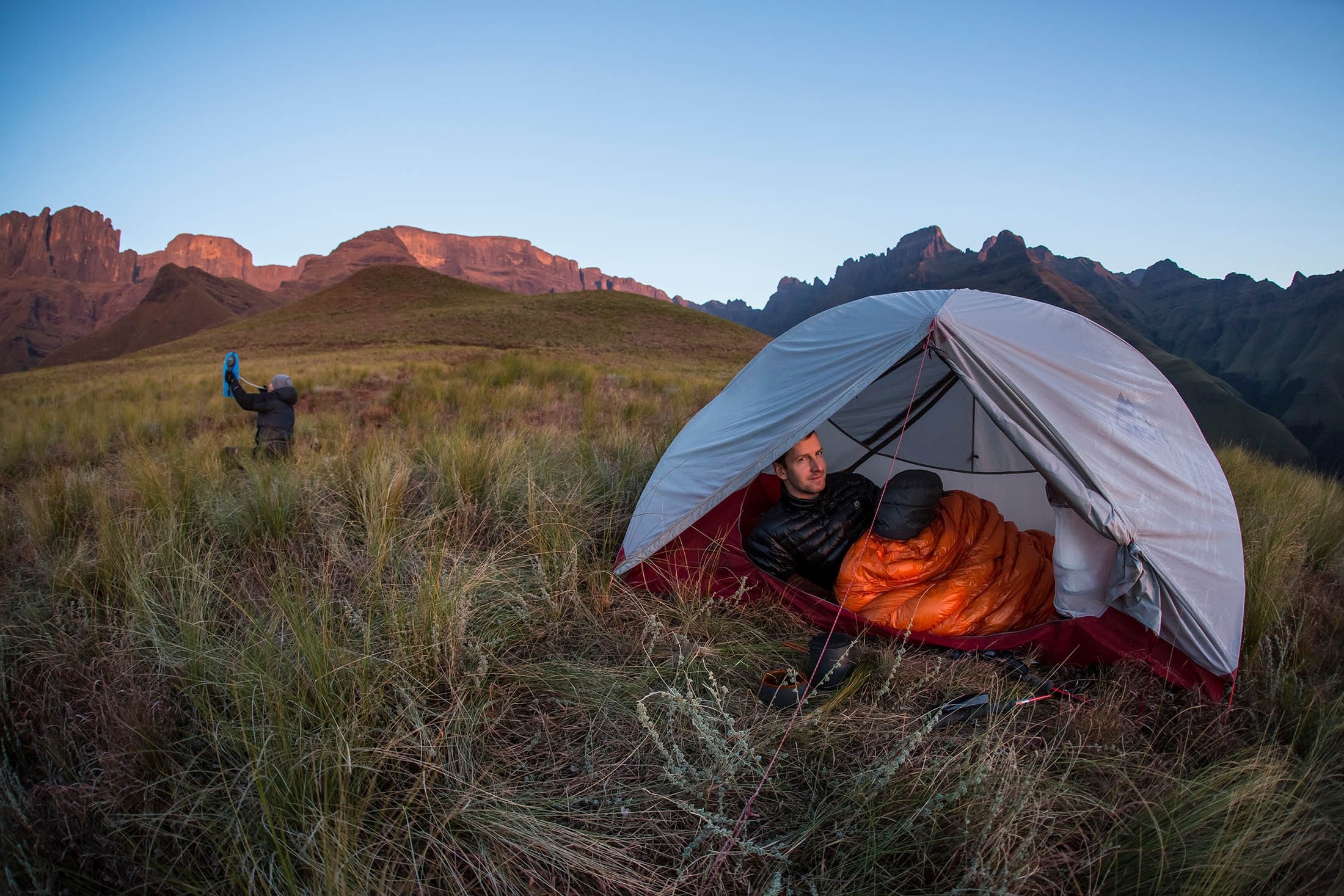 man sitting in tent with door open