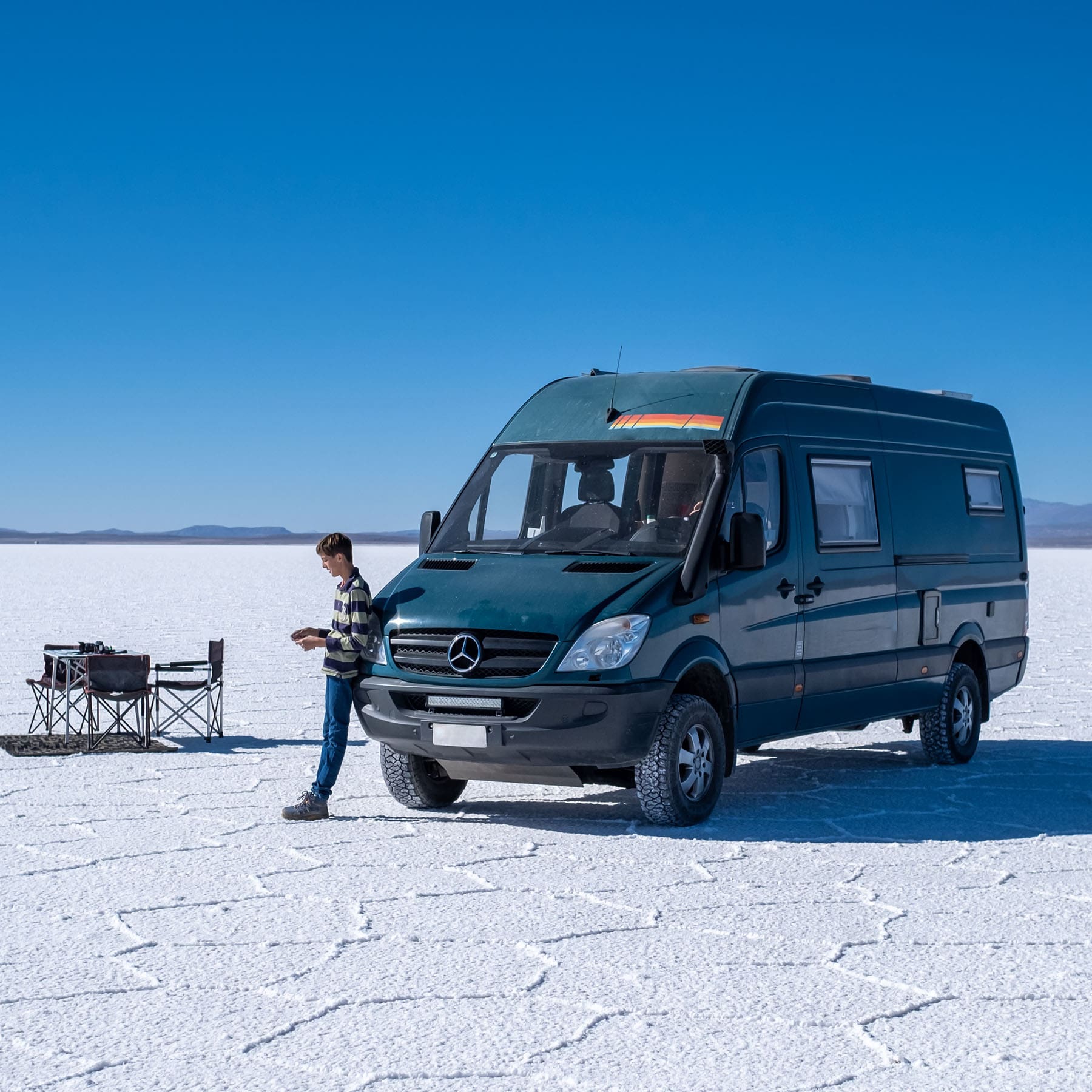 overland van parked on salt flat 