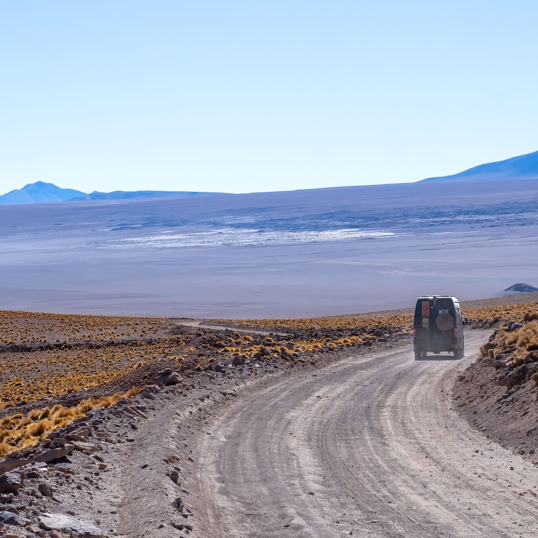 overland van disappearing down dirt road