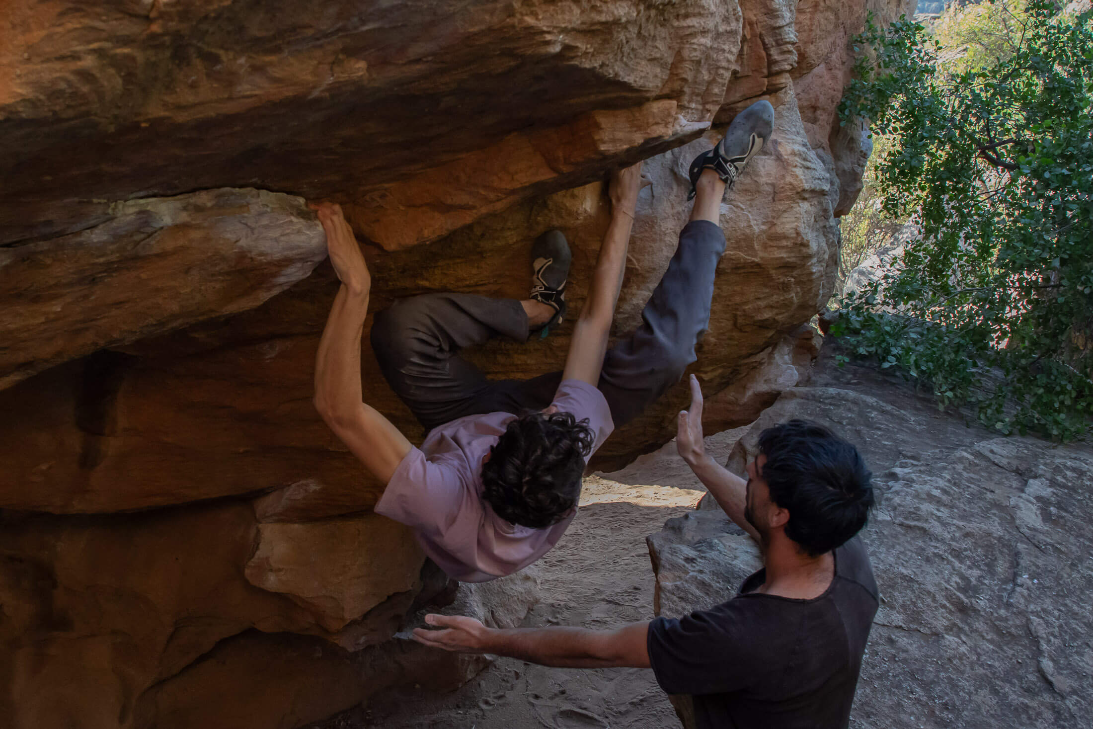 one boulderer spots another