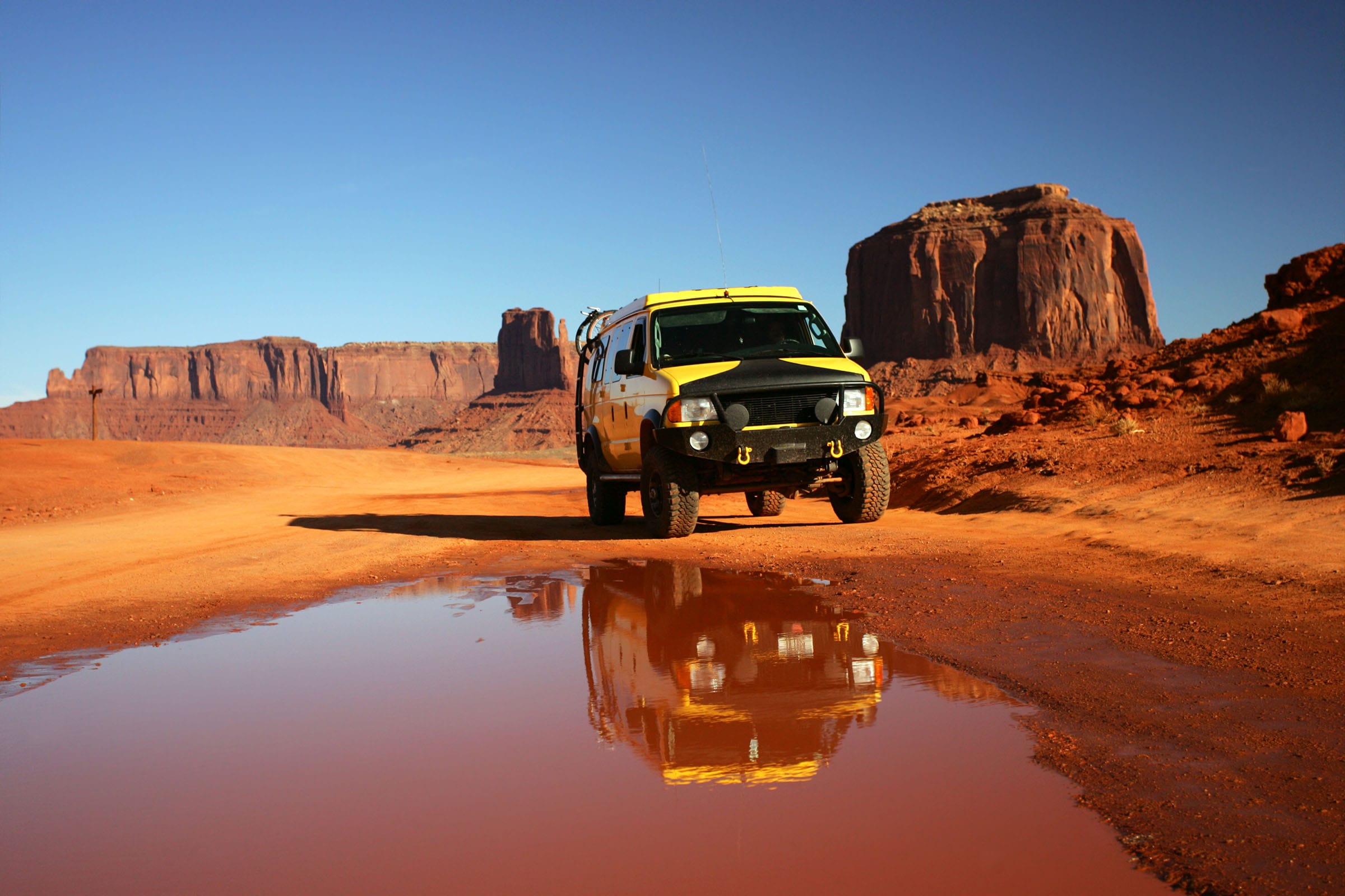 yellow overland van with desert landscape in background