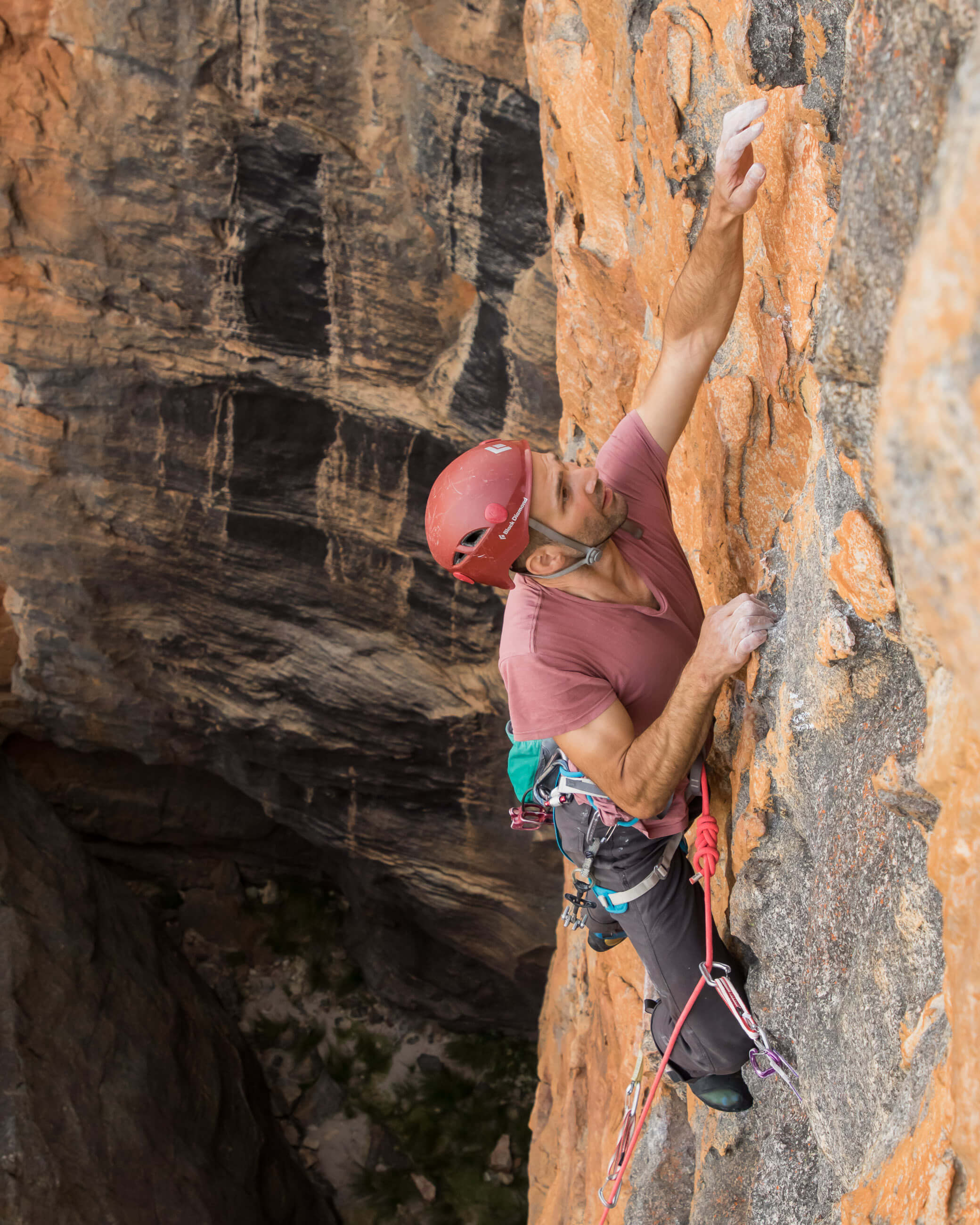 climber climbing above gear