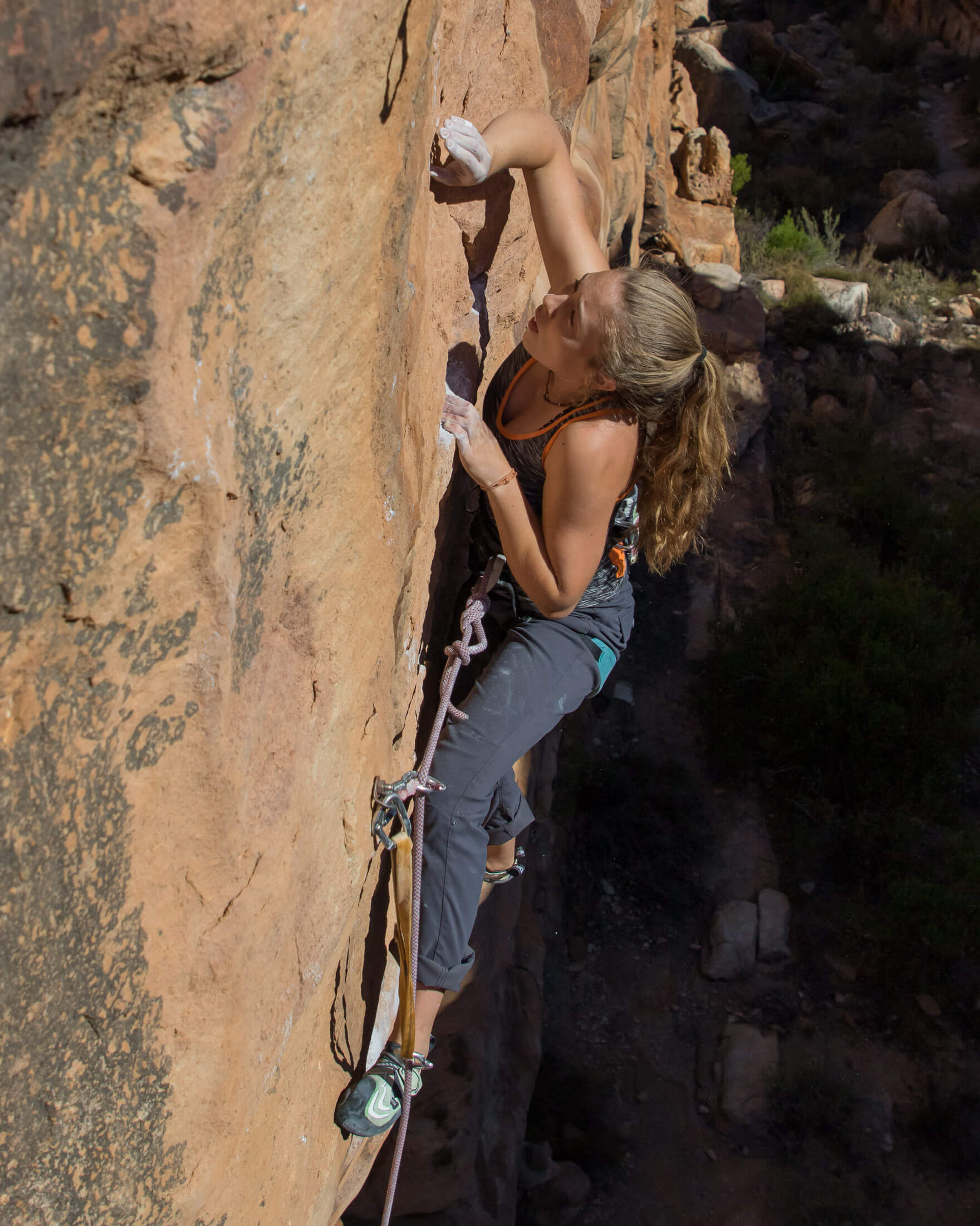 sport climber working the crux sequence on a route