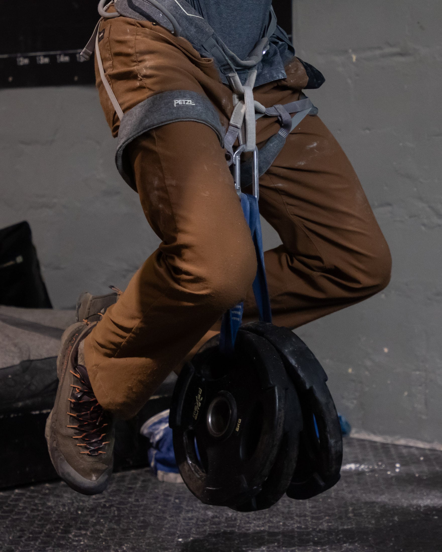 Climber hanging with weights attached to harness