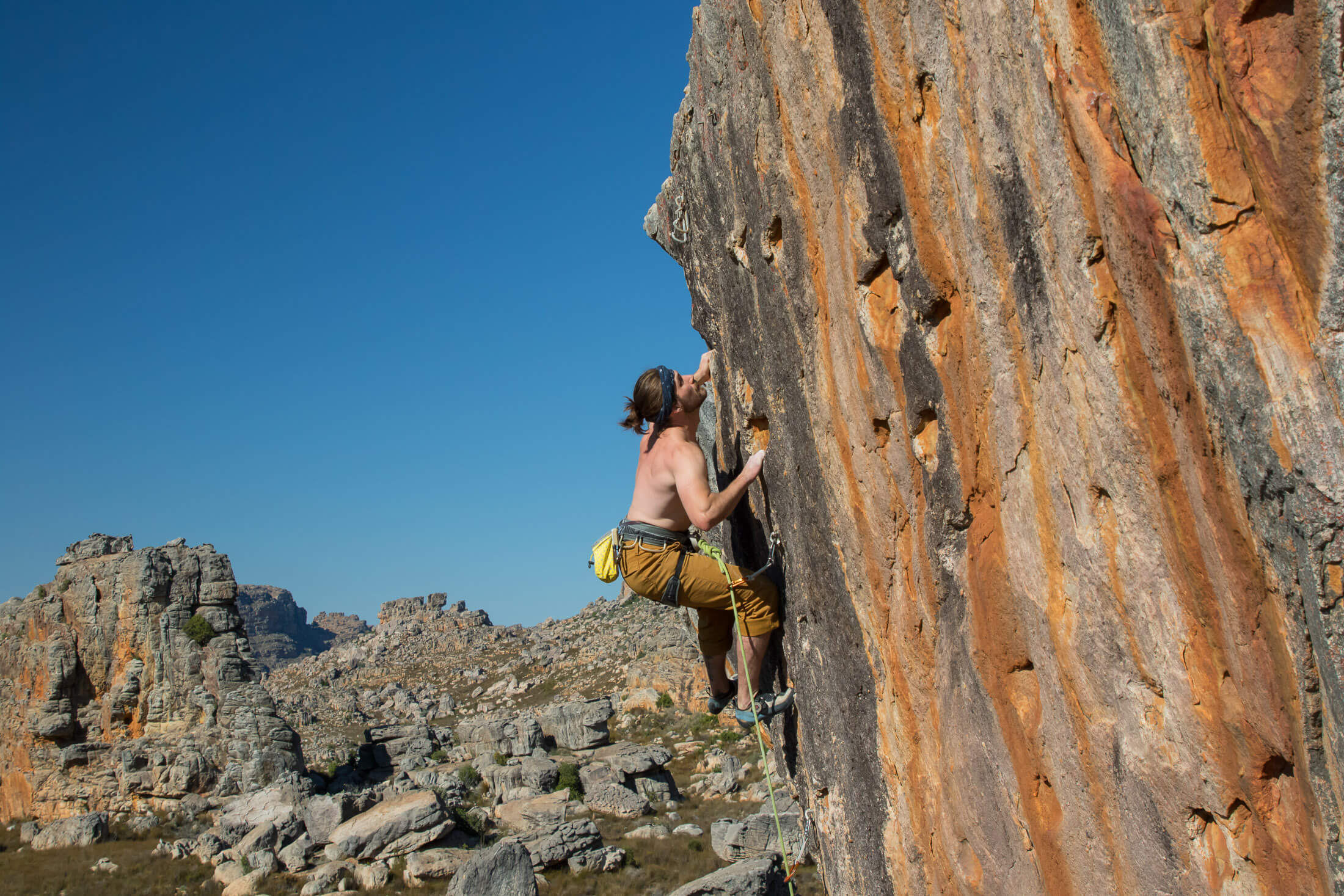 a climber pulls the last few moves on a route