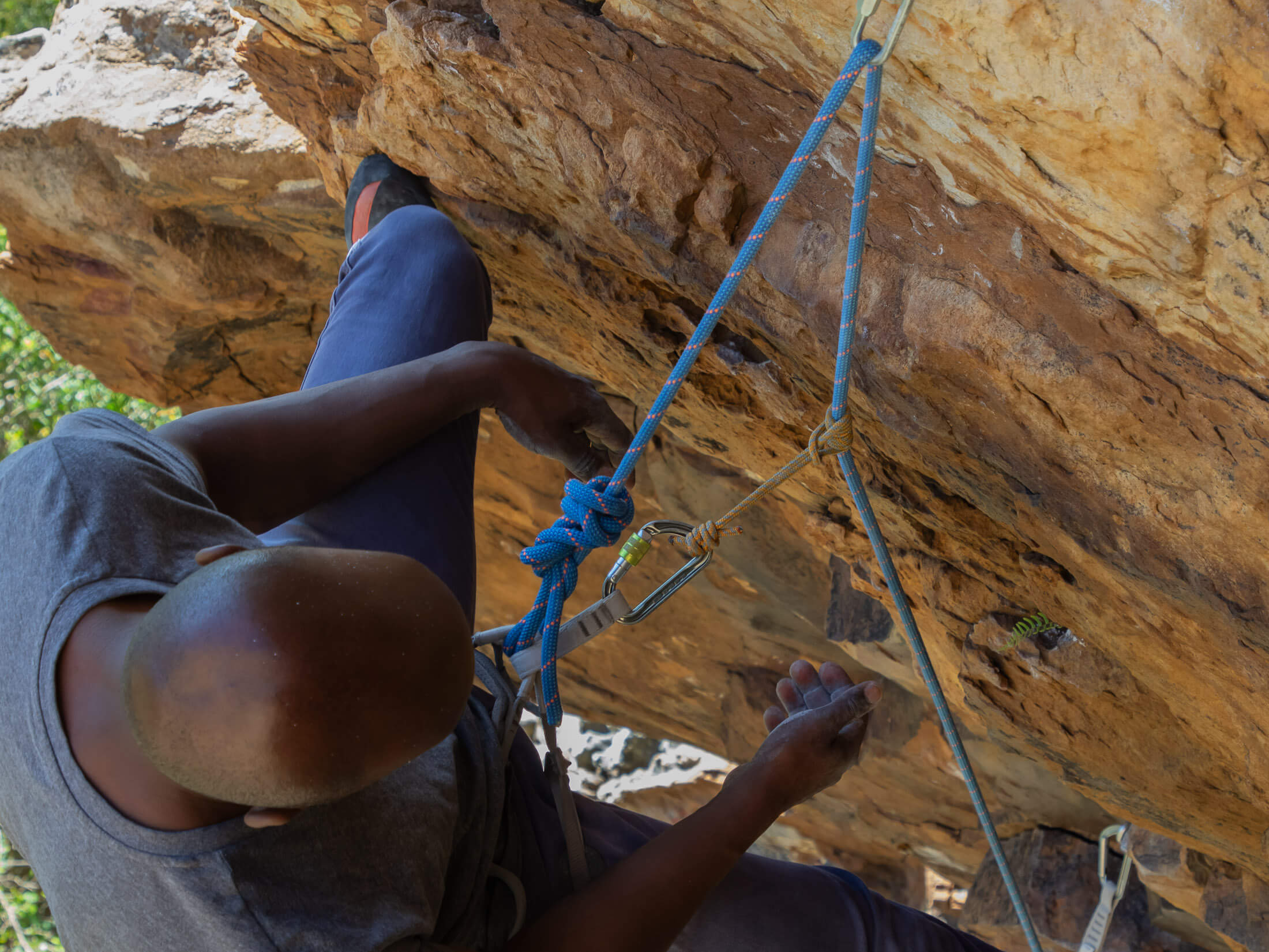 Climber using a prusik as a lower-off backup