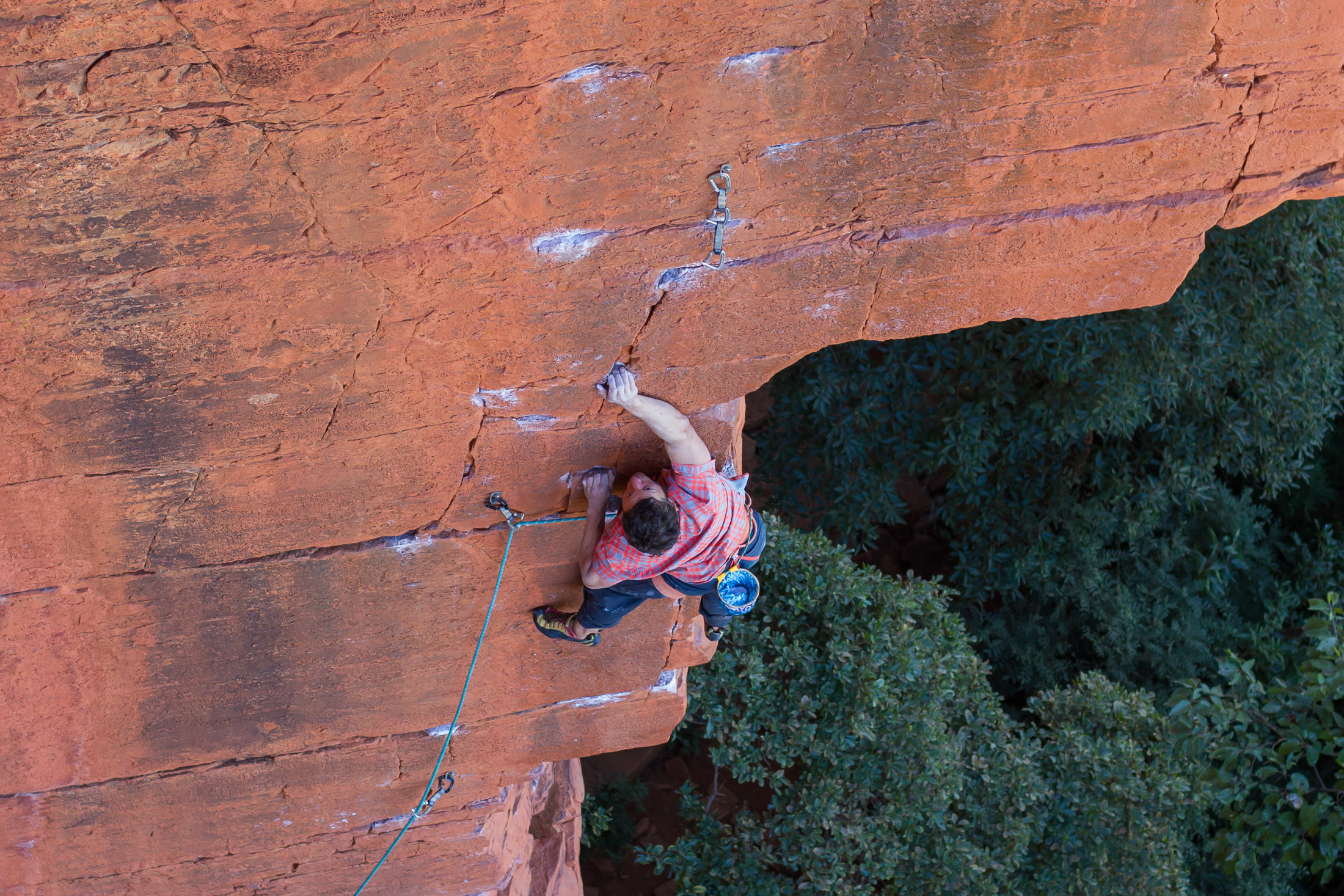 climber pulling long moves on hard route