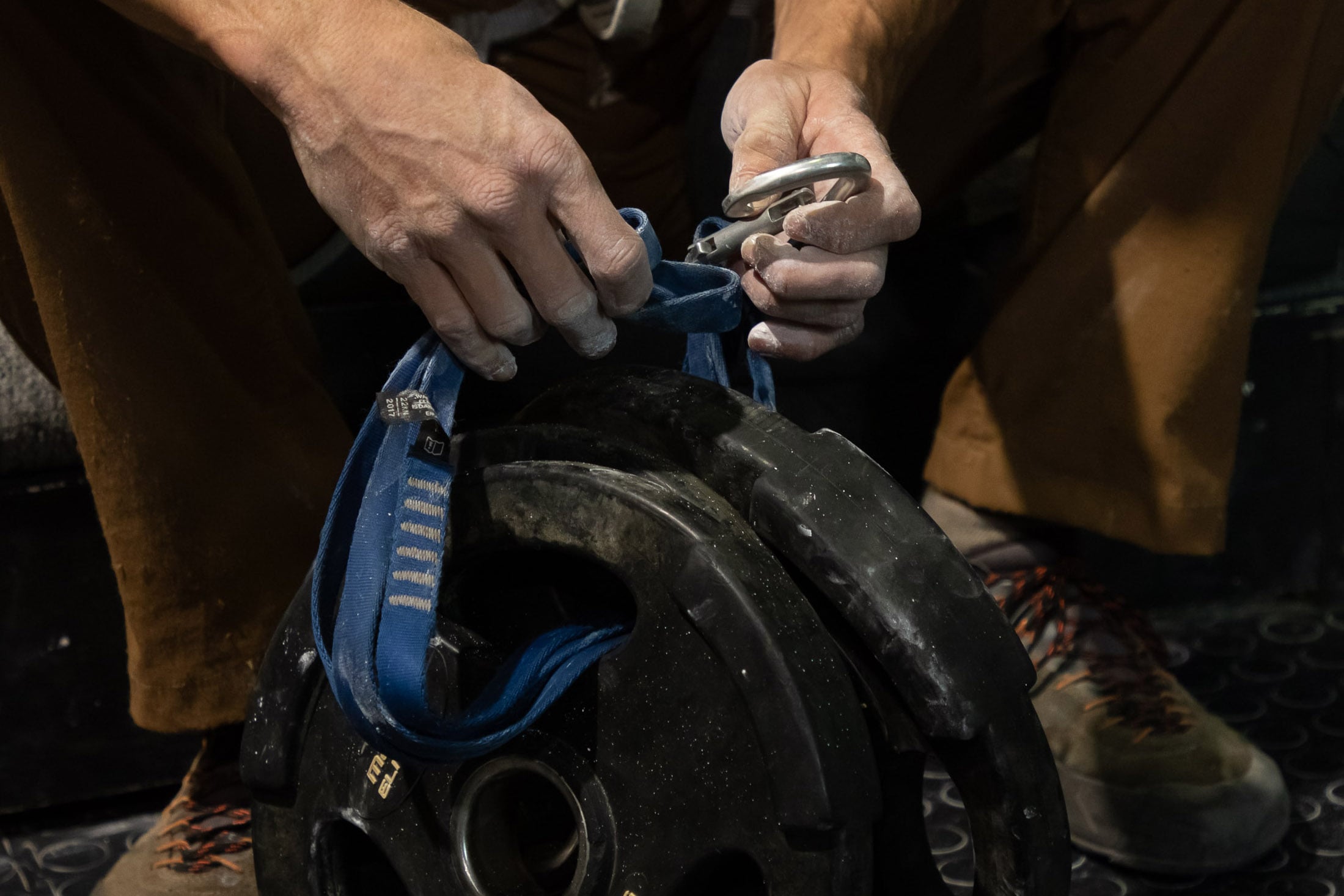 climber attaching weights to harness