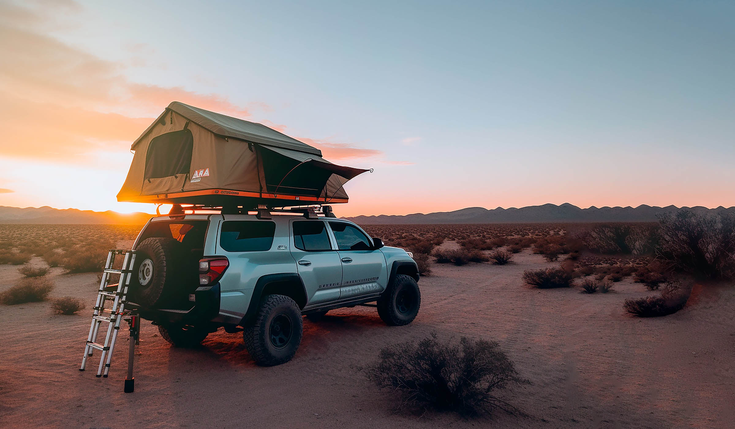 SUV with rooftop tent in desert