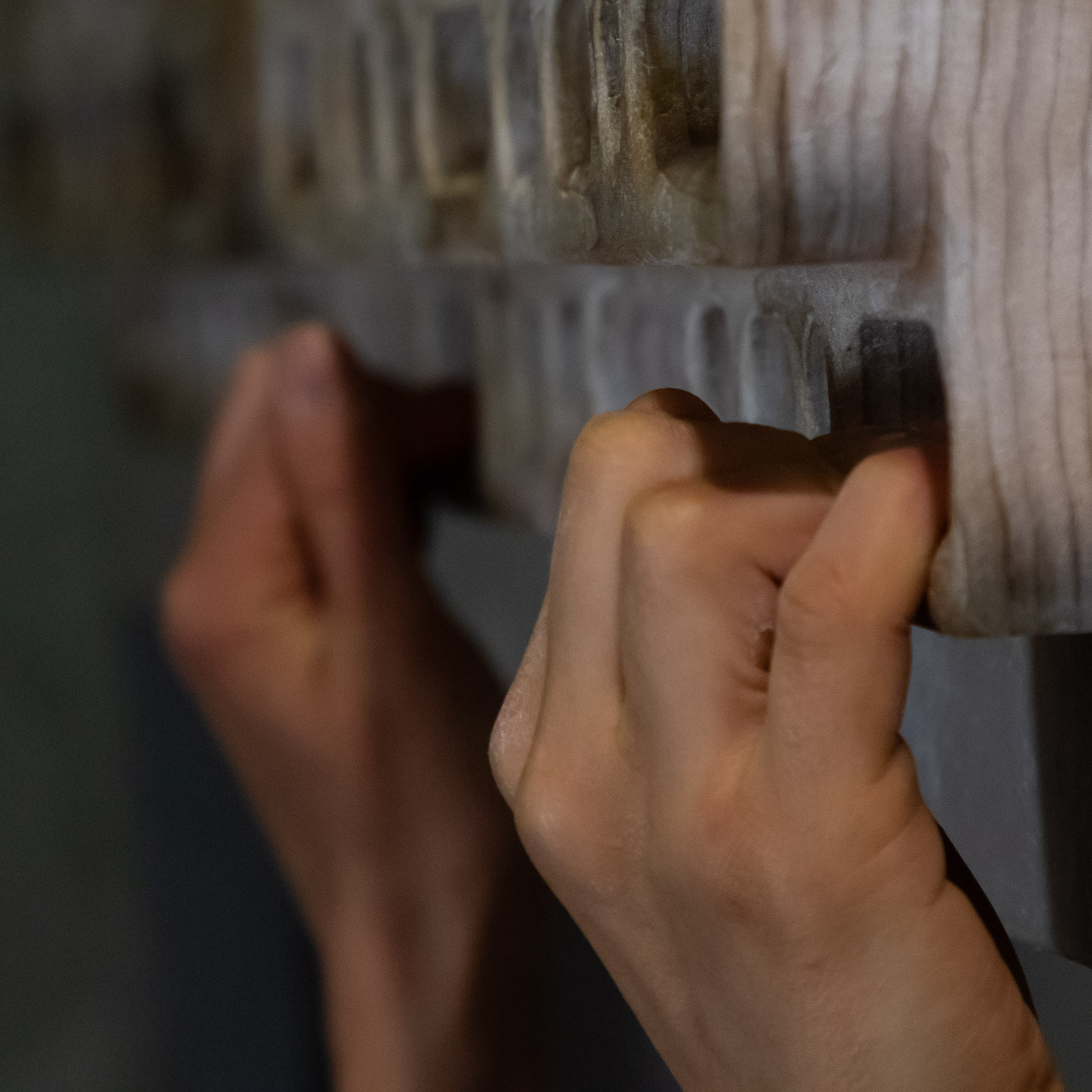 closeup of hands on hangboard