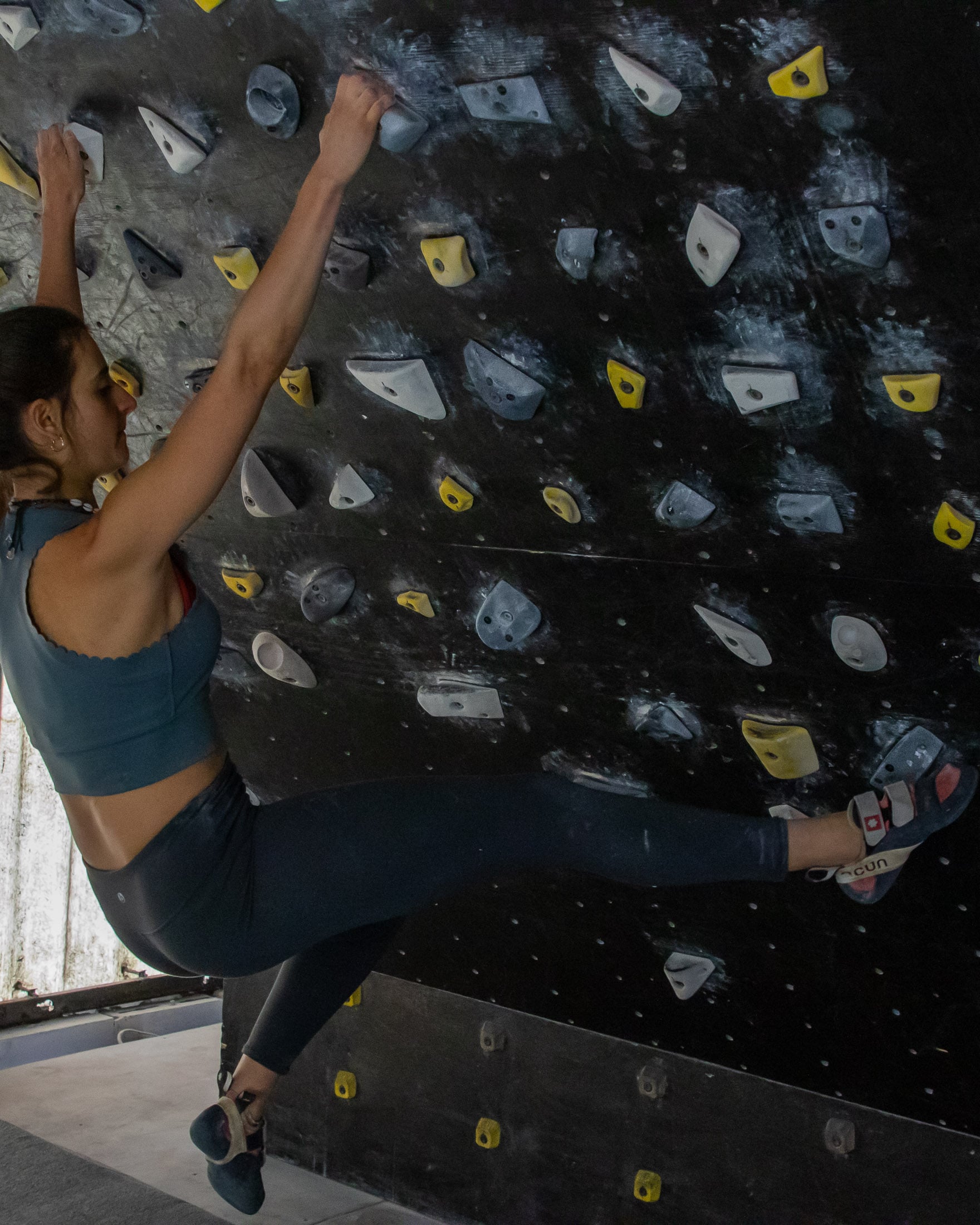 Climber doing core exercise on Moon board