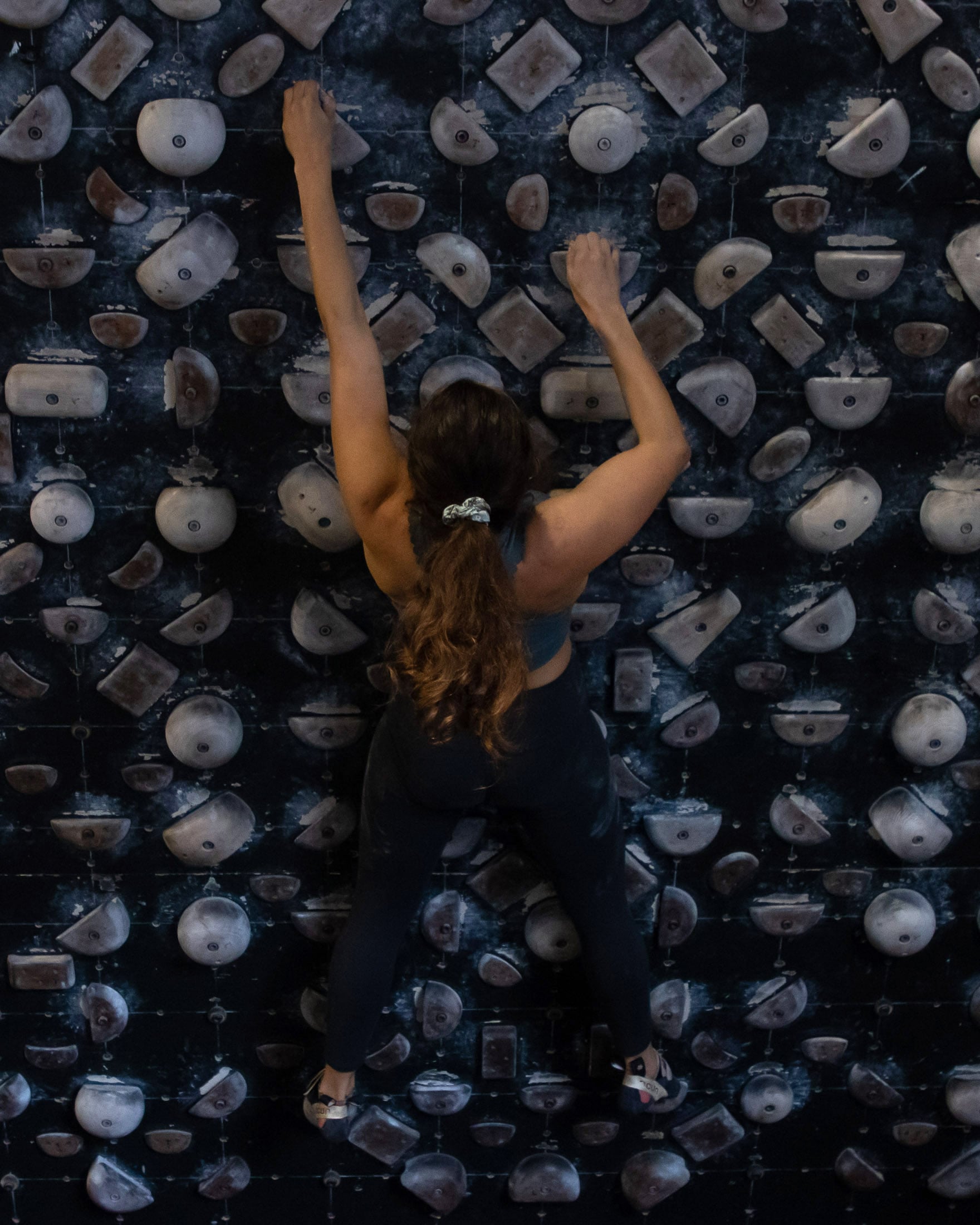 Climber doing core exercise on systems wall