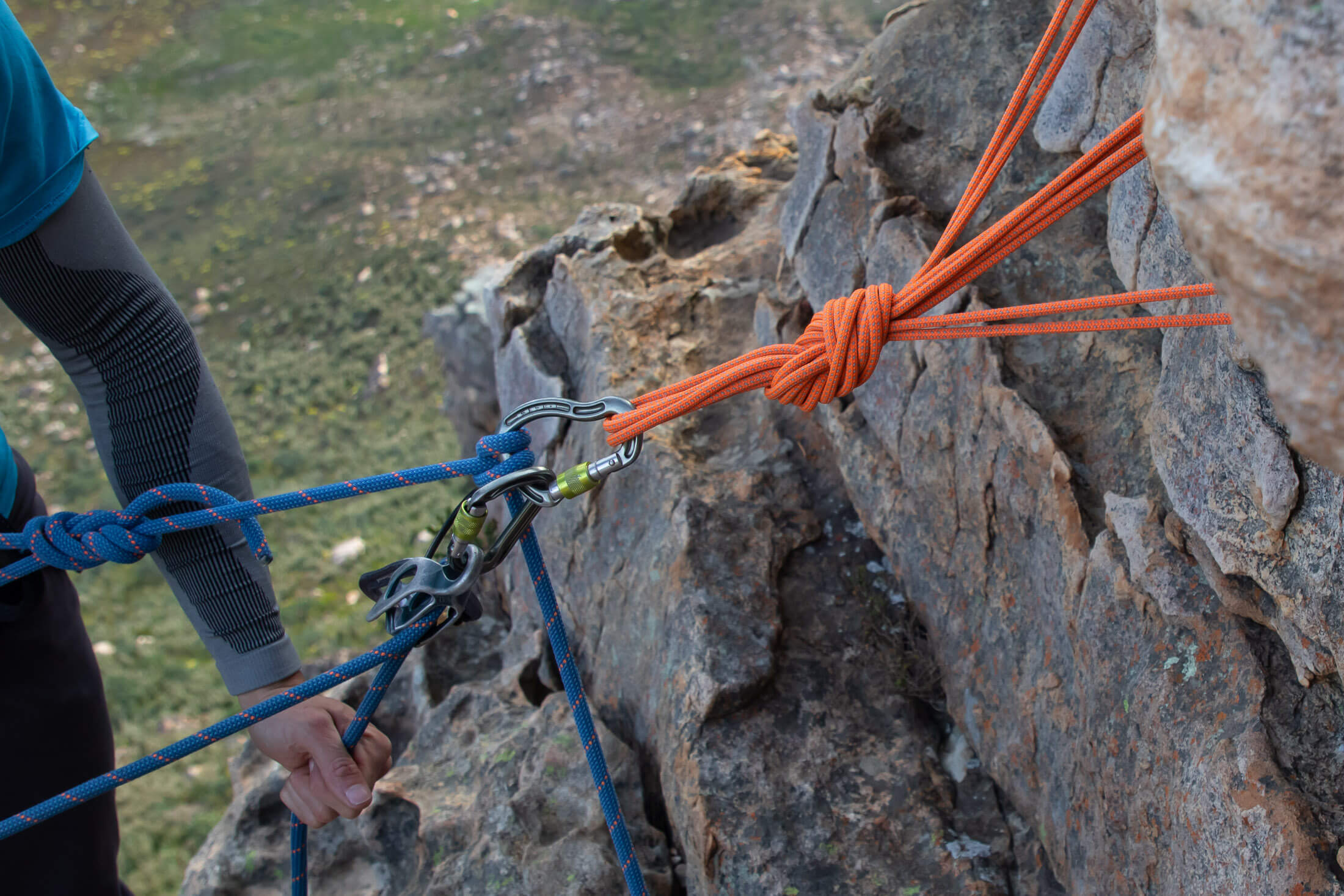 climber connected to anchor with rope
