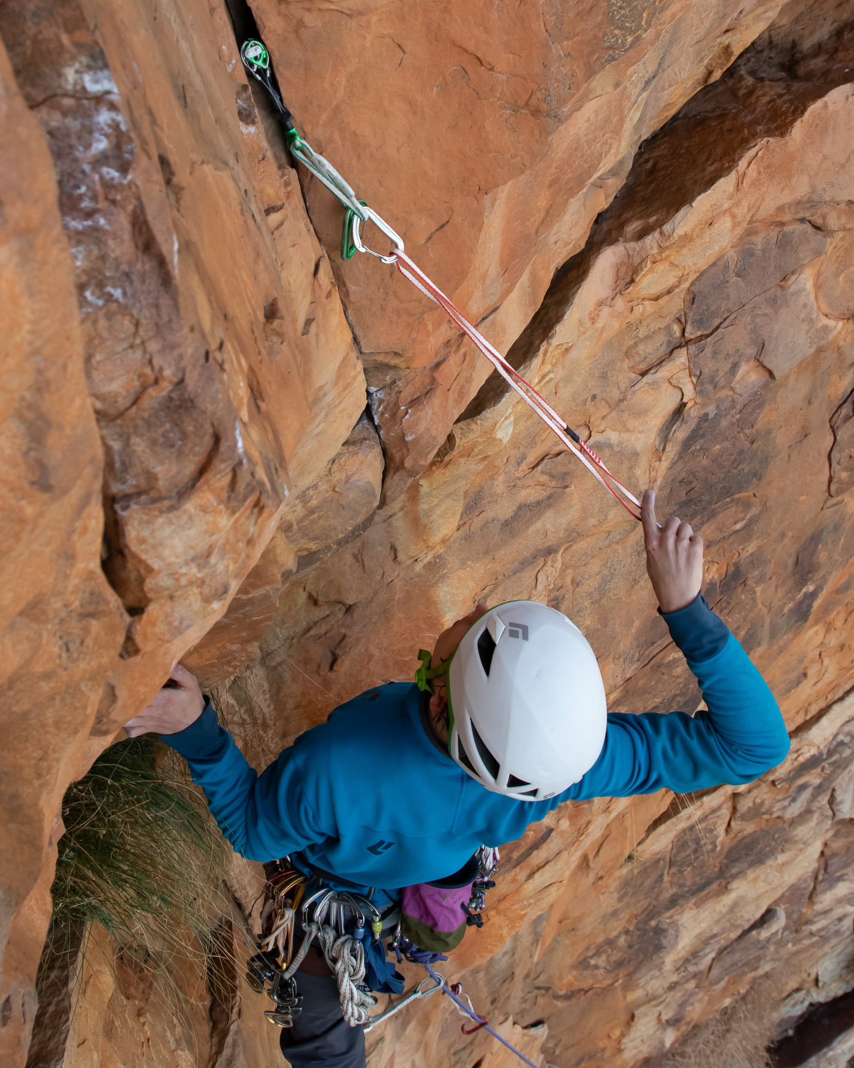 climber extending protection with sling