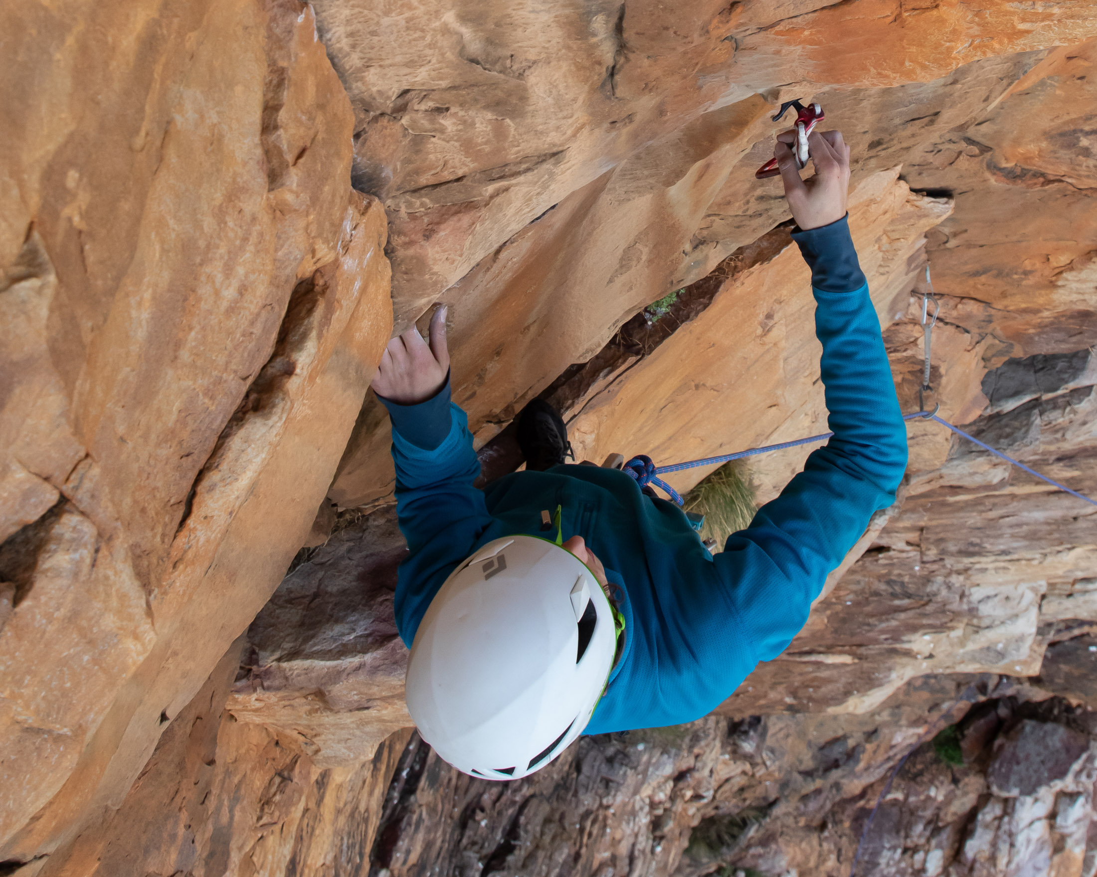 climber placing cam under roof