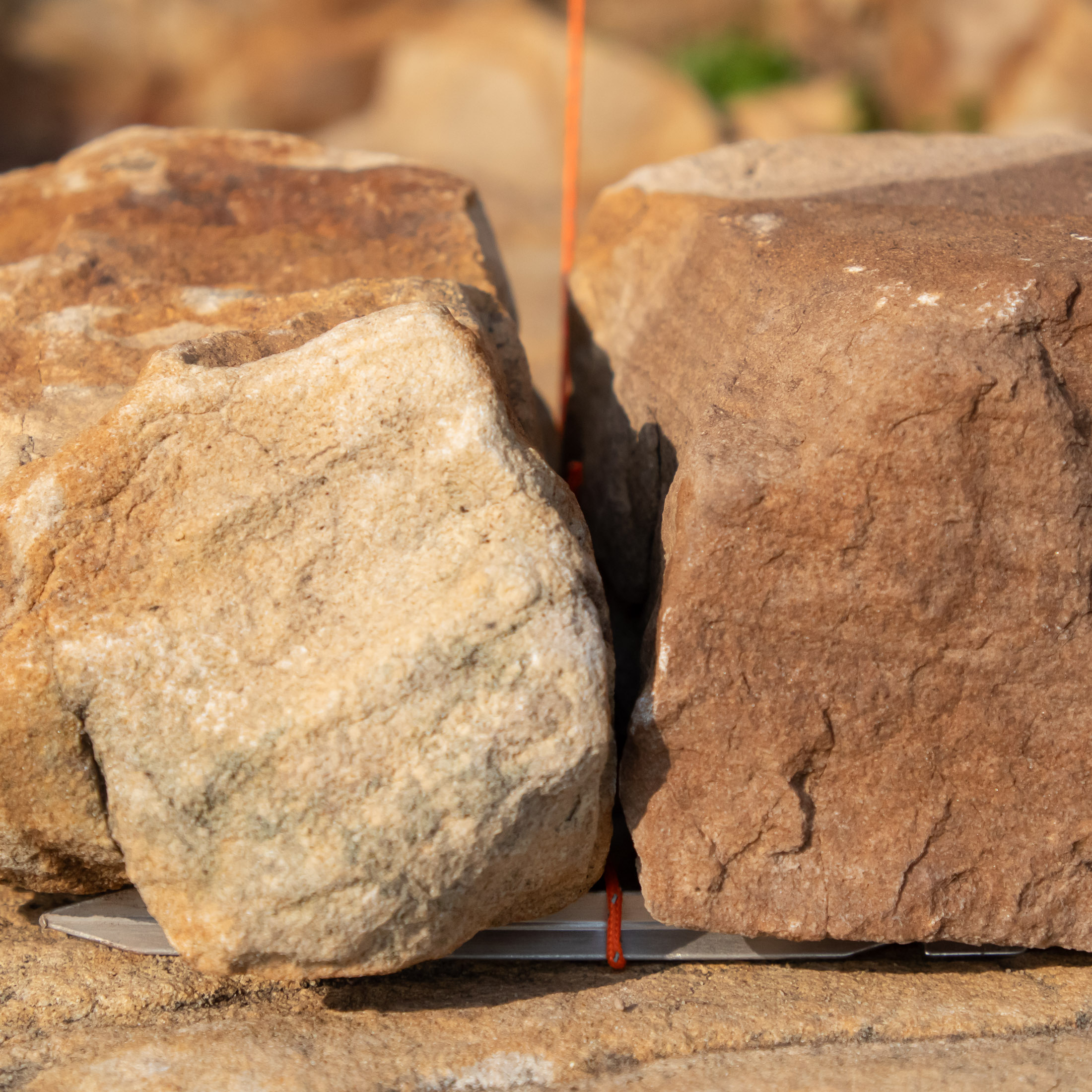 stake pinned down with rock