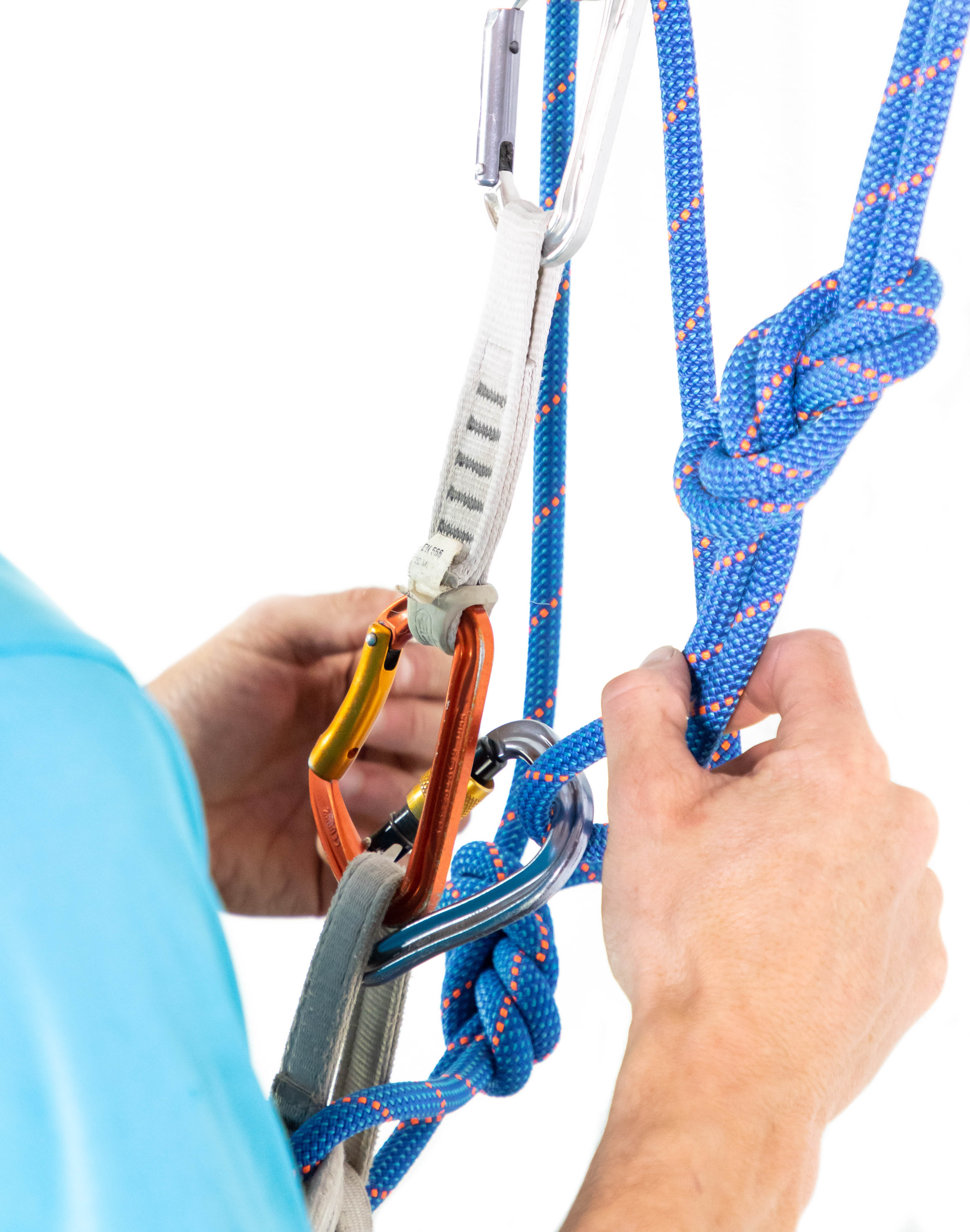 climber clipping figure 8 knot to harness with carabiner