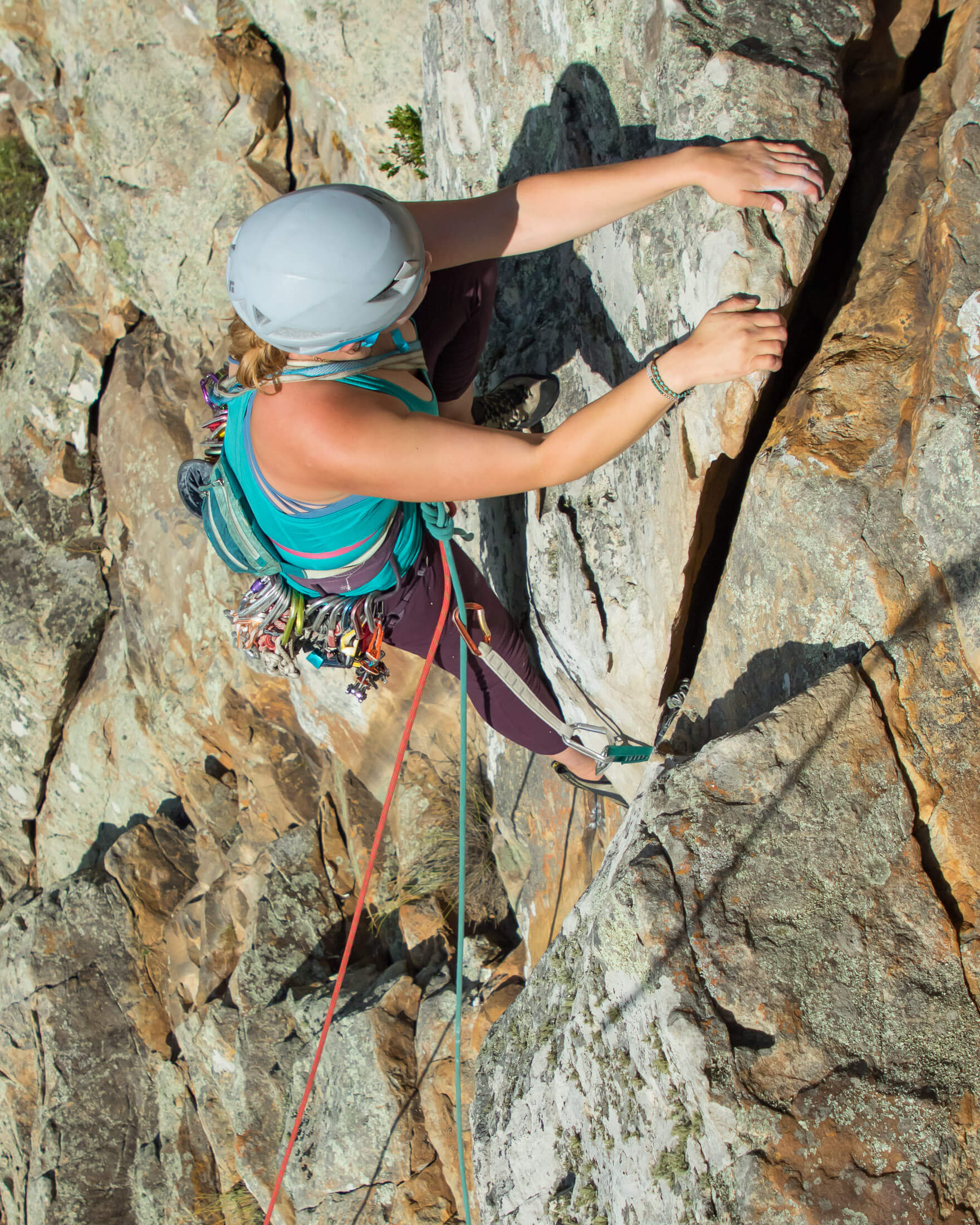 climber leading trad route using double ropes