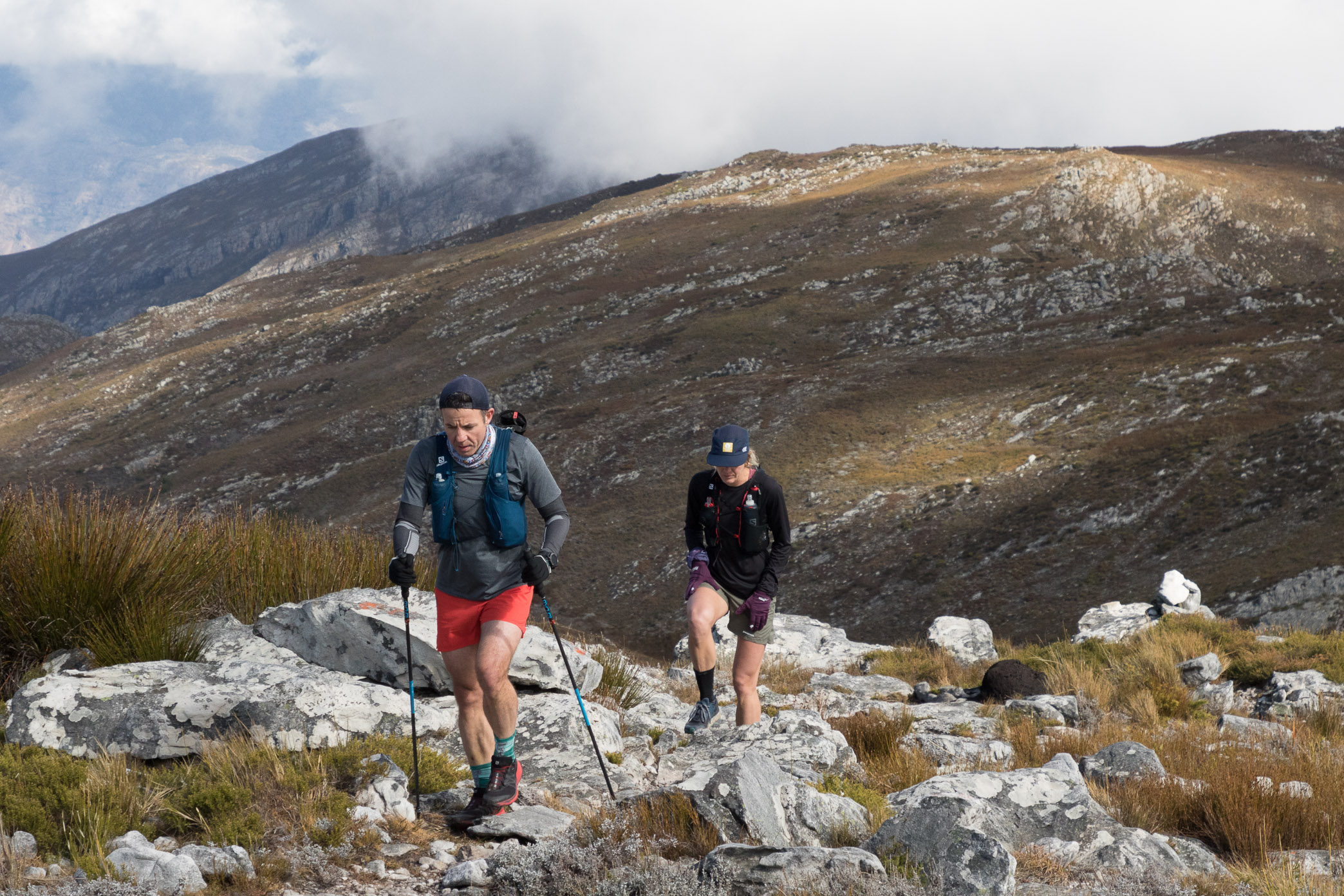 runners using trekking poles