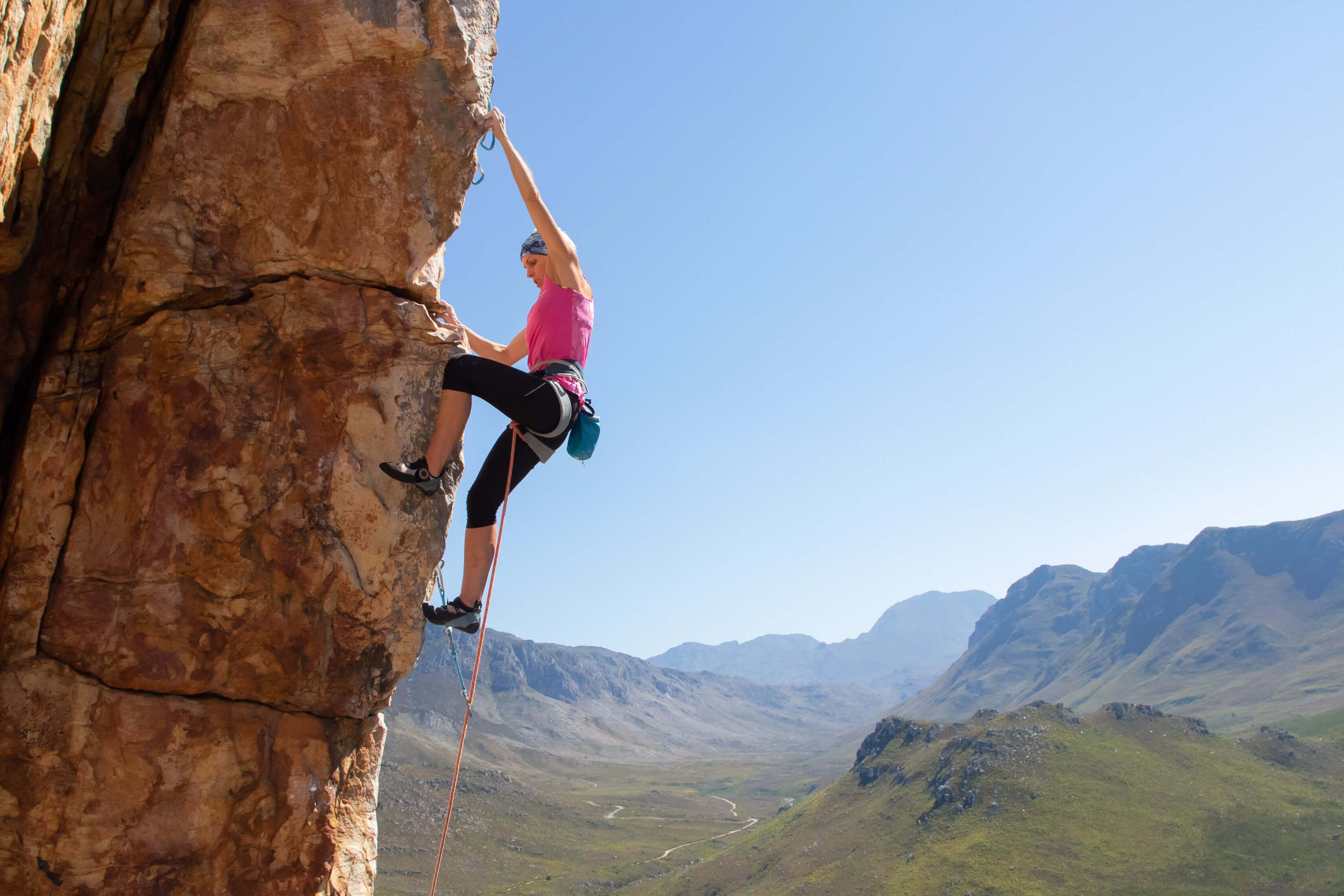 Climber pulling crux moves high above the ground