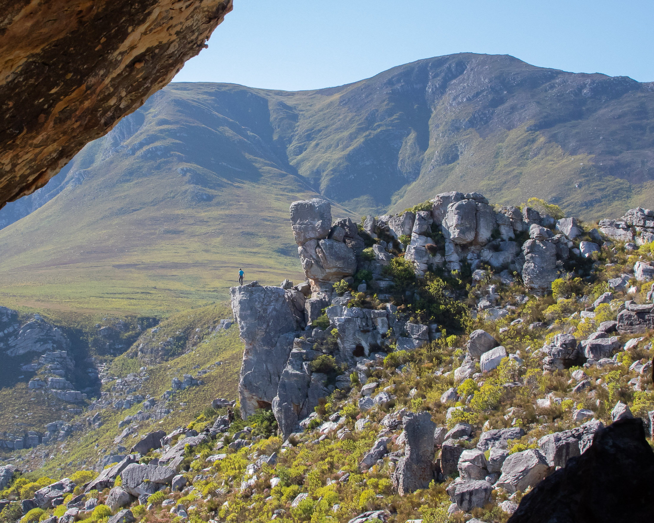 climber standing on top of crag