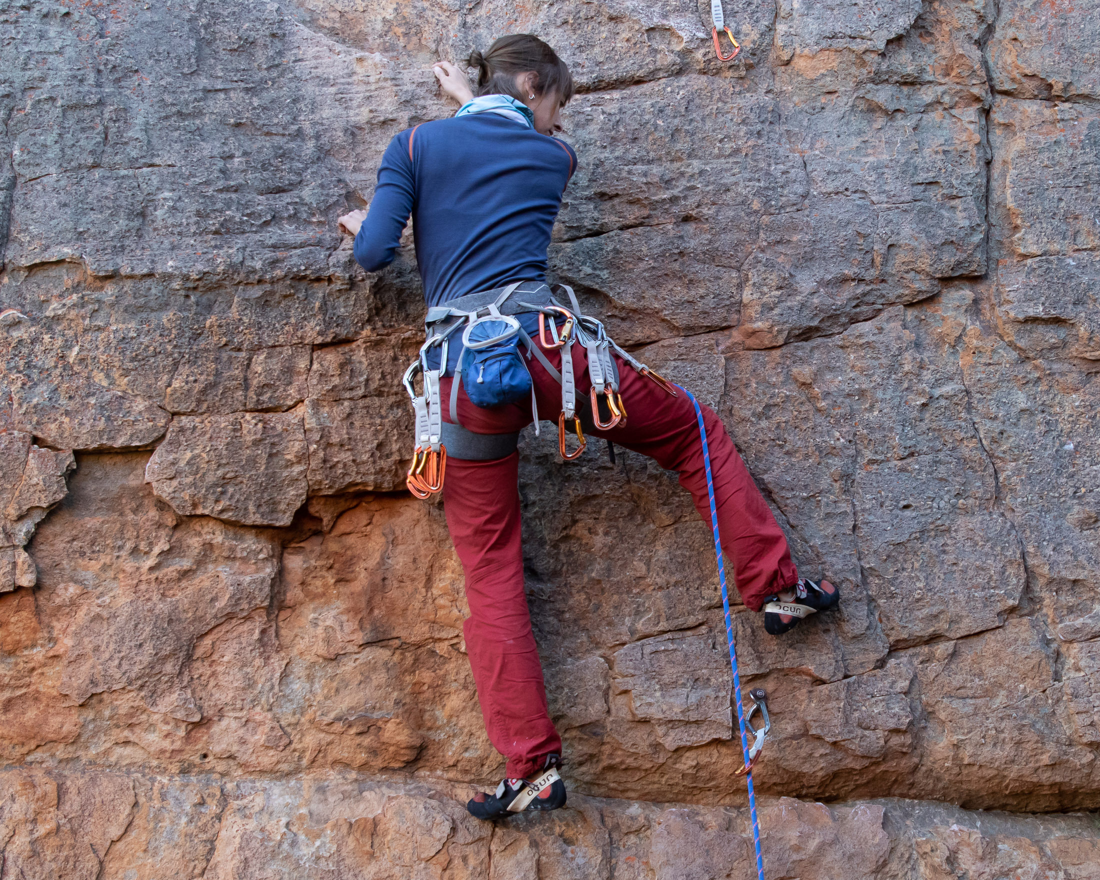 Climber with leg behind rope
