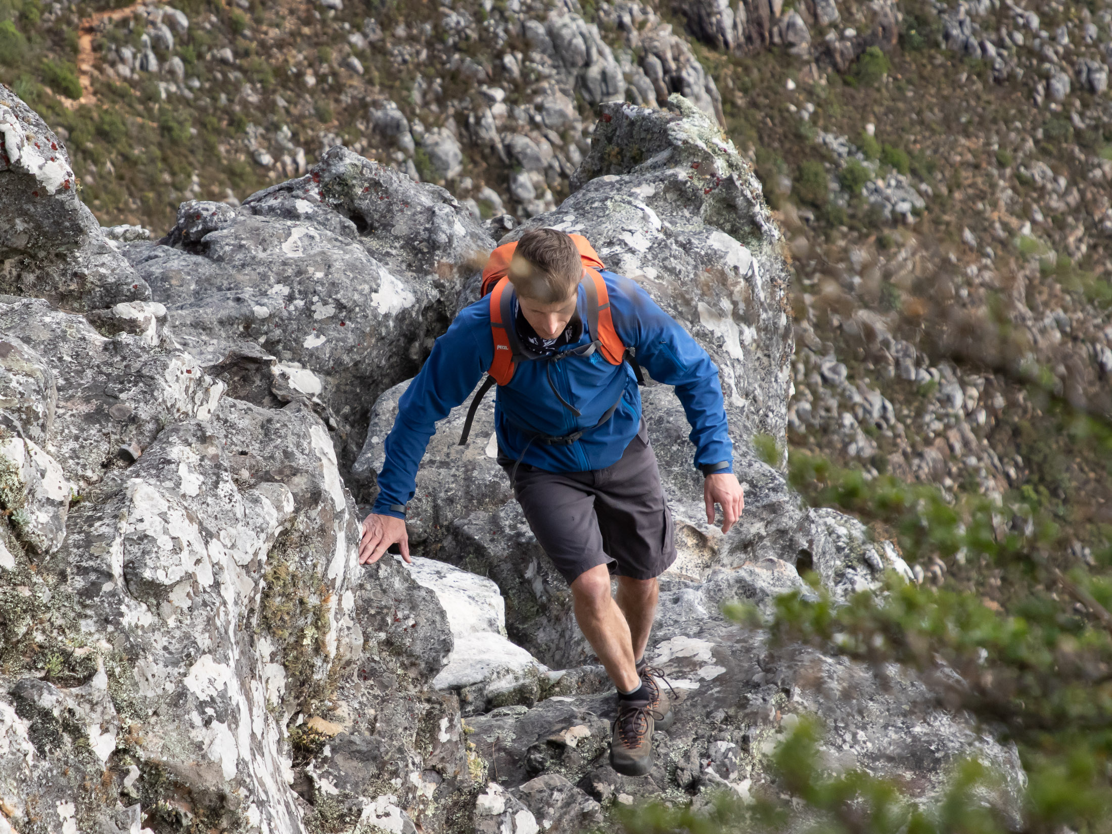 a hiker navigating his way over steep terrain