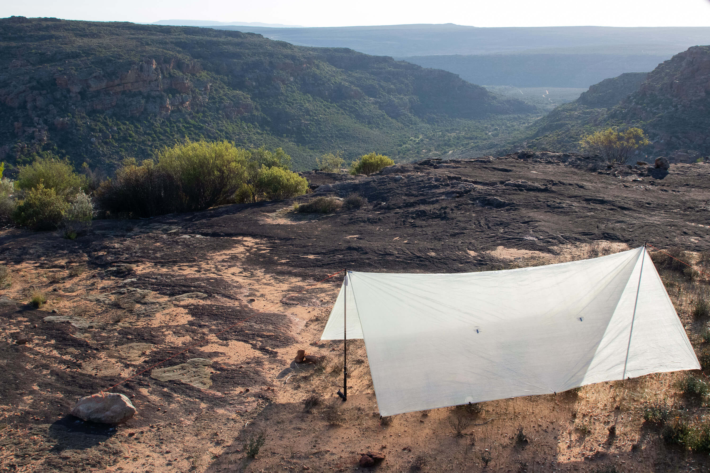 tarp rigged with trekking poles