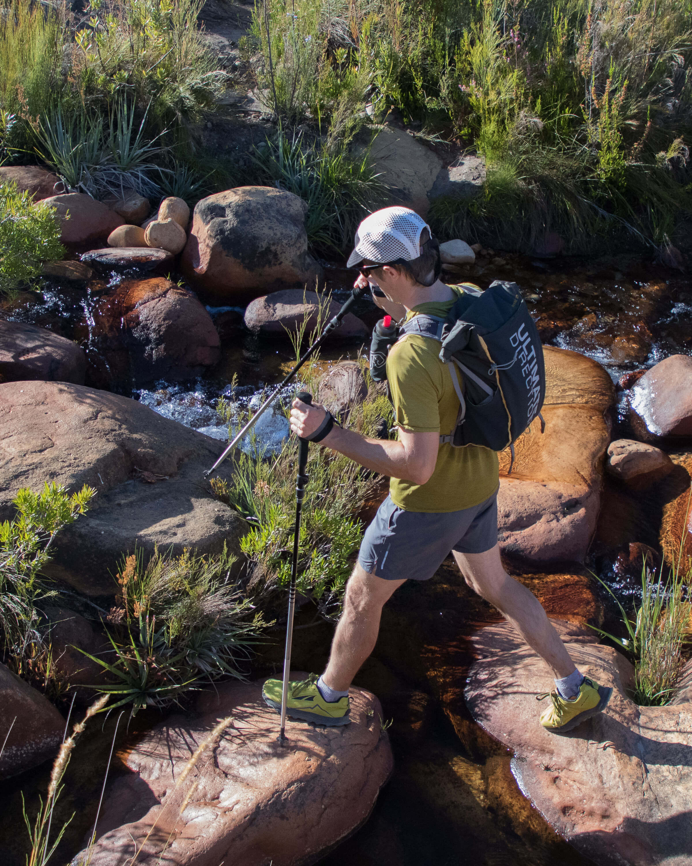 crossing river with trekking poles