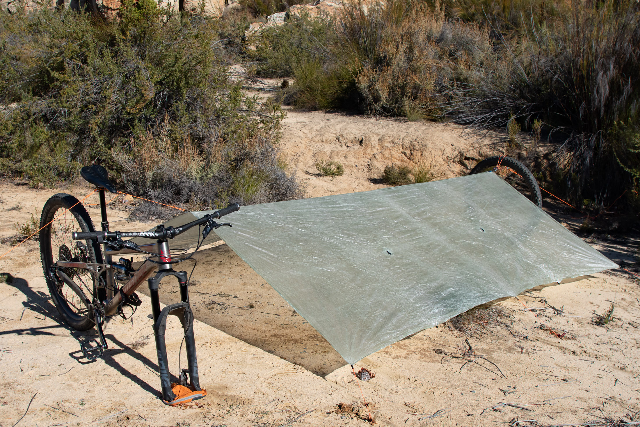 tarp rigged with bike for support