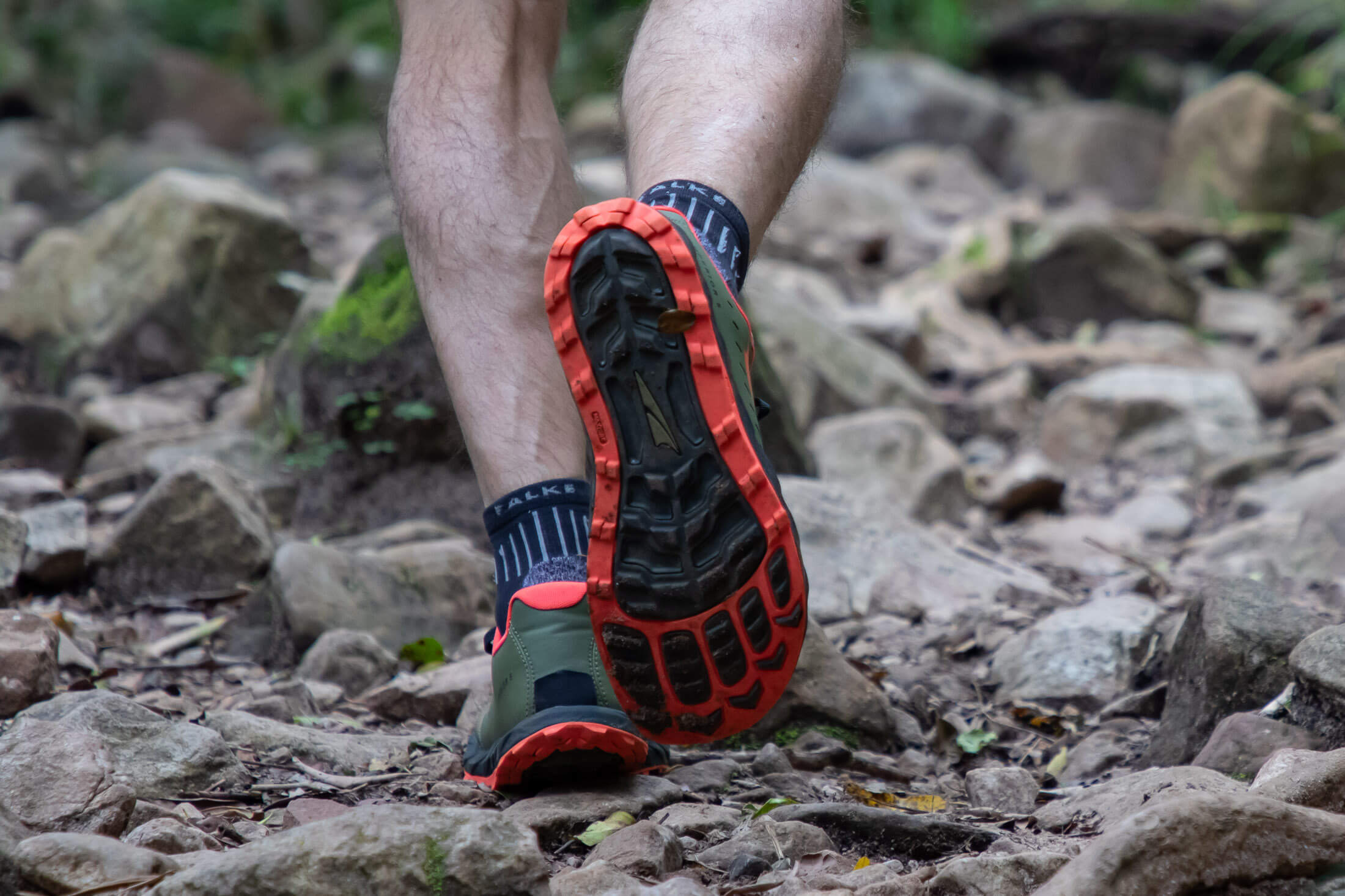 runner negotiating rocky trail