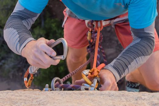 climber cleaning top anchors