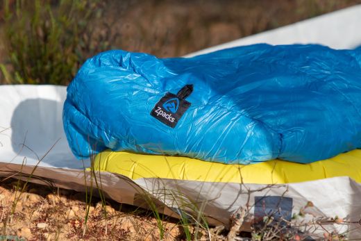 Backpacking quilt laid out on sleeping pad