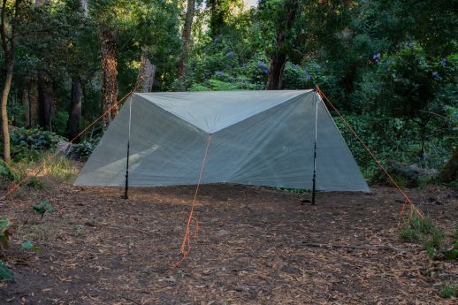 Tarp in wind shed configuration