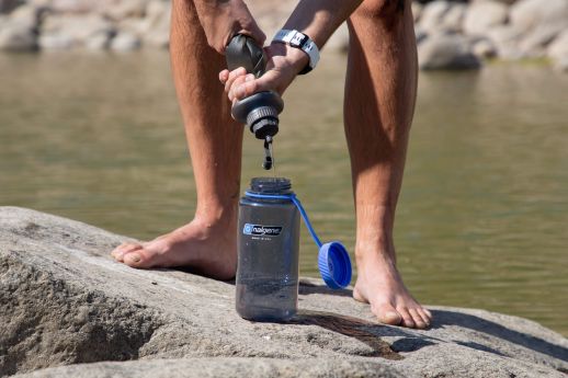 hiker filtering water